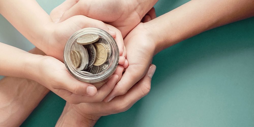 child and parent hands holding money jar, donation, saving, charity, family finance plan , dividend, superannuation concept