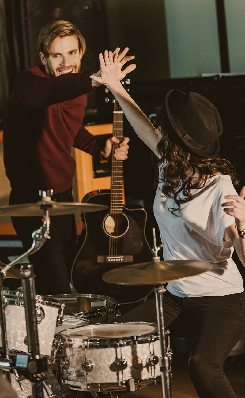 young musicians giving high five on repetition
